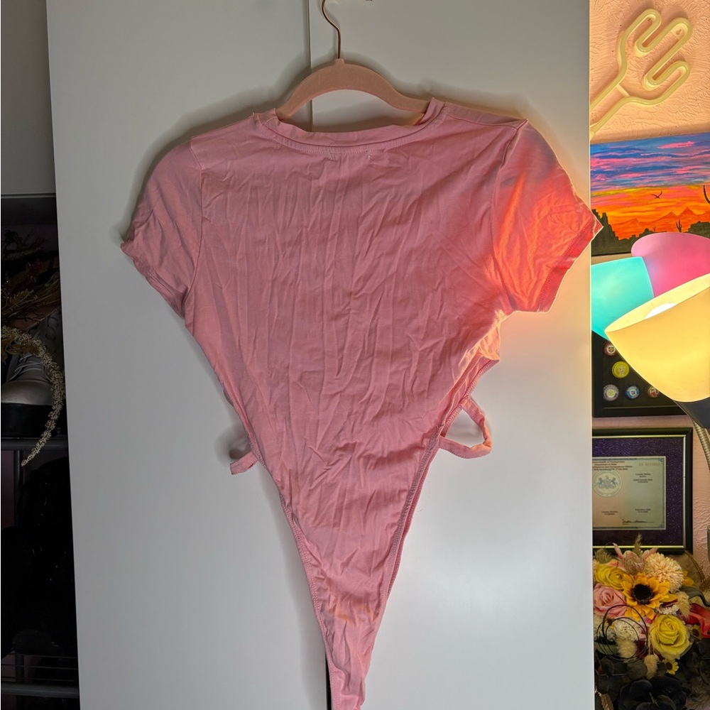 Pink bodysuit, hip cut outs